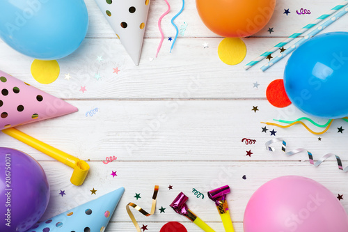 Flat lay composition with birthday party items on wooden background