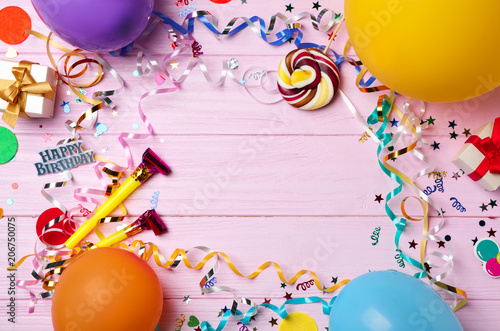 Flat lay composition with birthday party items on wooden background