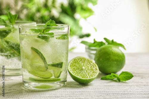 Refreshing beverage with mint and lime on table