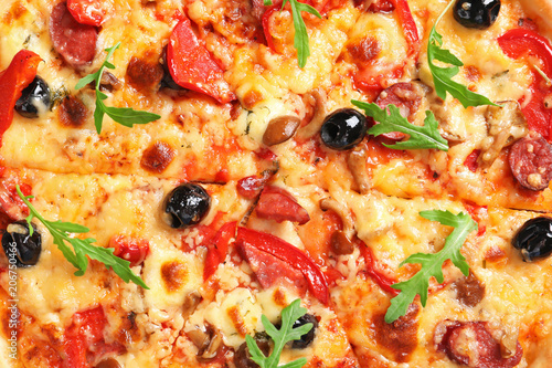 Delicious pizza with olives and sausages, closeup