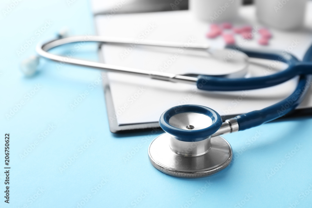 Stethoscope and clipboard on color background, closeup. Medical equipment Stethoscope and clipboard on color background, closeup. Medical equipment