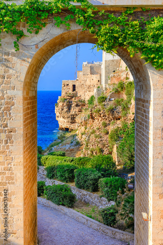 Fototapeta Naklejka Na Ścianę i Meble -  Polignano a Mare, Puglia, Italy: Ponte di Polignano bridge with Bastione di Santo Stefano and Lama Monachile beach in background, Apulia, Italy, Cala Paura gulf, province of Bari