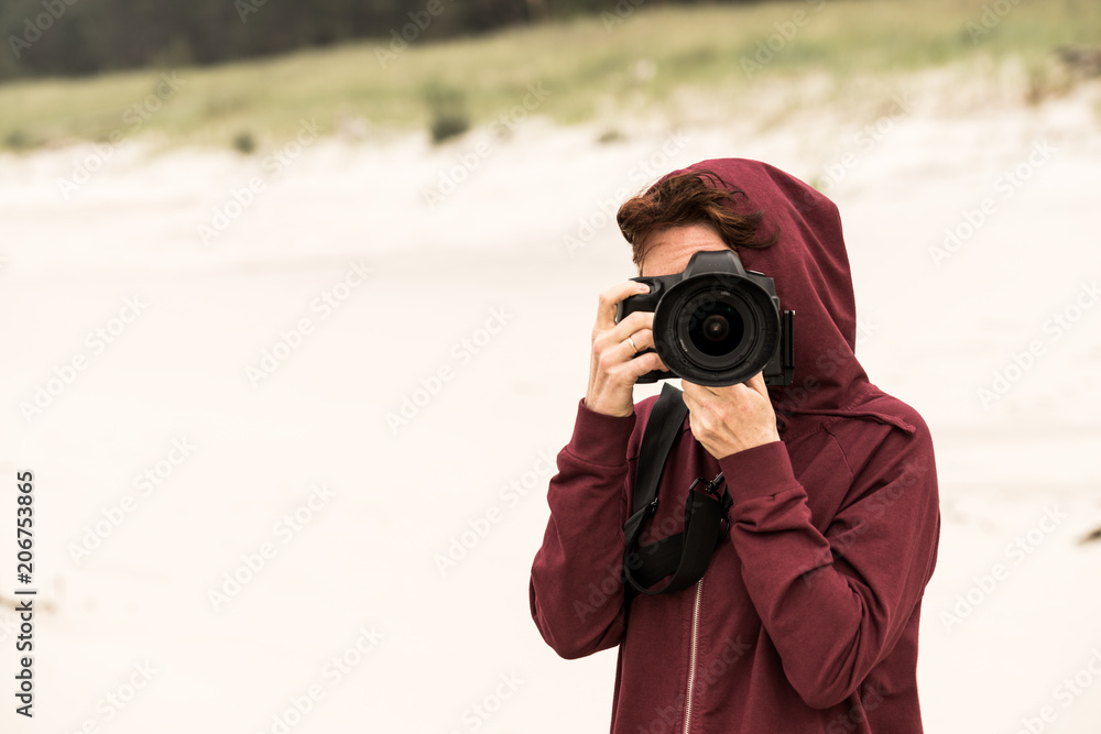 Woman taking pictures on coastline