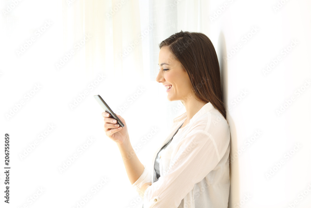 Profile of a girl using a smart phone isolated at side Profile of a girl using a smart phone isolated at side