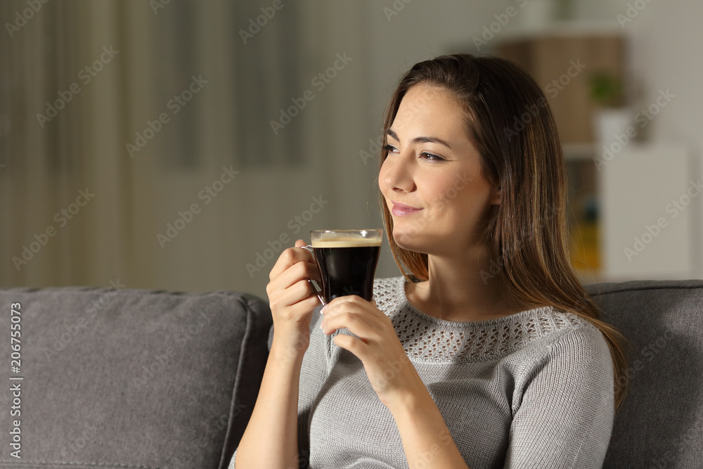 Satisfied woman enjoying coffee in the night Satisfied woman enjoying coffee in the night