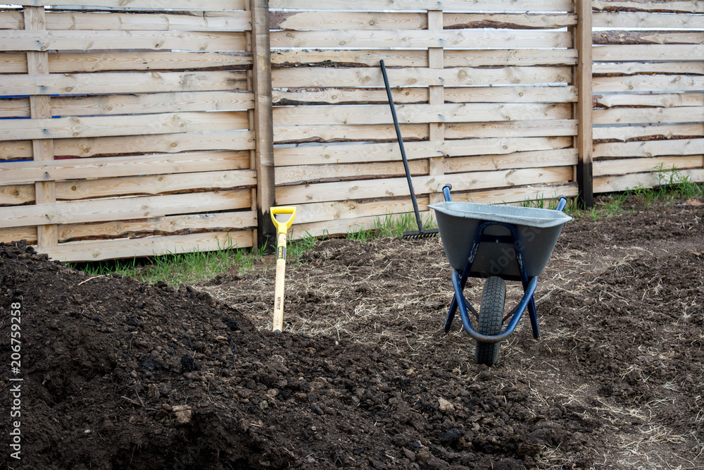 Garden wheelbarrow, shovel and humus. Garden wheelbarrow, shovel and humus.