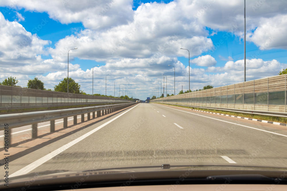 road, blue sky background with clouds, view from the car. road, blue sky background with clouds, view from the car.