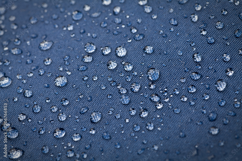Drops of water on blue waterproof cloth Drops of water on blue waterproof cloth