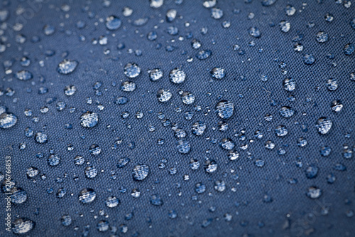 Drops of water on blue waterproof cloth
