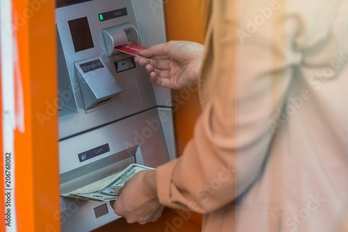 woman withdrawing the cash via ATM, business Automatic Teller Machine concept