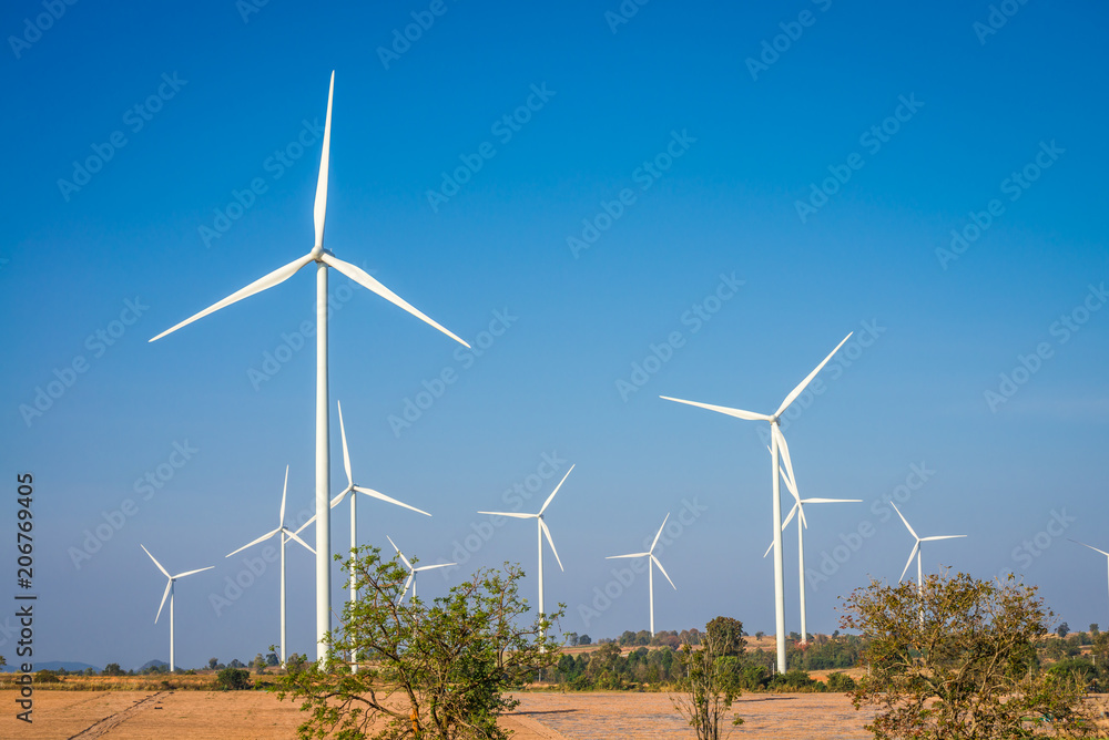 Wind turbines generating electricity on mountain with blue sky Wind turbines generating electricity on mountain with blue sky