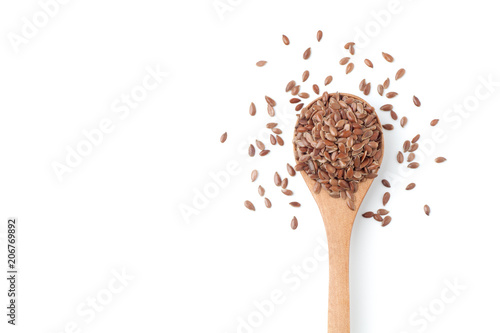 Flax seeds in a wooden spoon on white background
