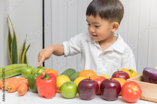 Healthy and nutrition concept. Kid learning about nutrition how to choose eating fresh fruits and vegetables.