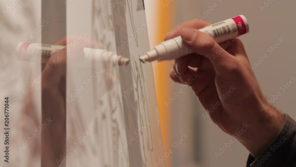 Man Draws and Writes on Glass Surface. Man Draws and Writes on Glass Surface.