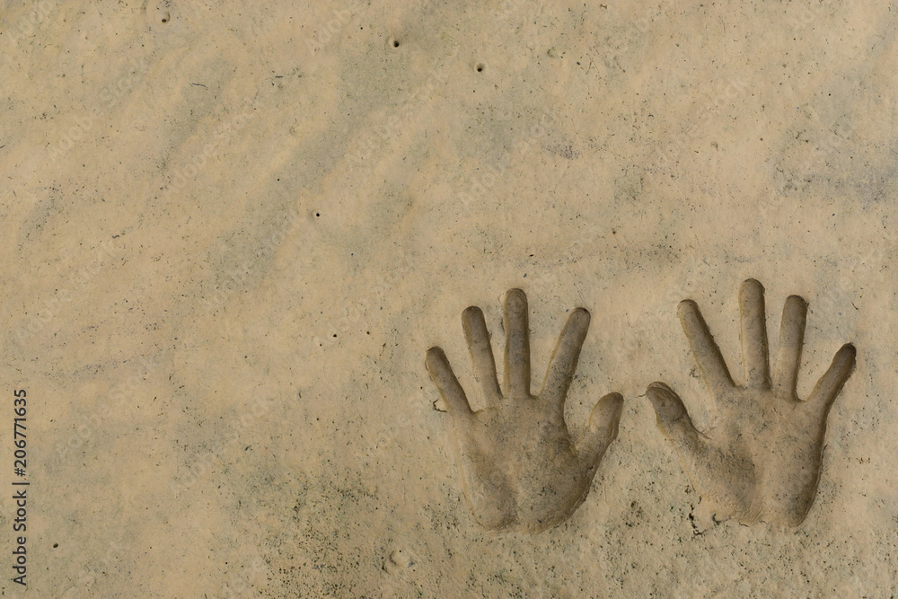 The hands print on mud ground after water receded The hands print on mud ground after water receded
