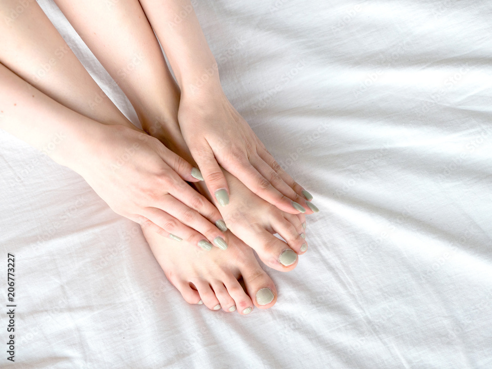 Young woman massaging her foot on the bed. Healthcare concept. Young woman massaging her foot on the bed. Healthcare concept.