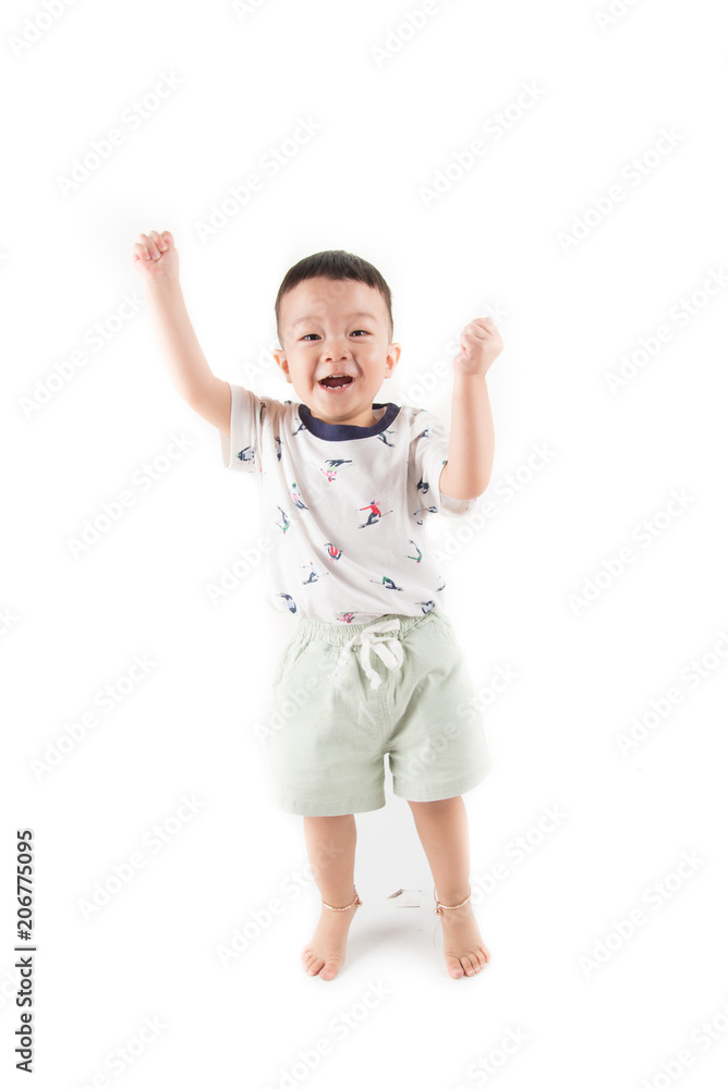 Happy toddler boy jumpping with smile face say Huray on white background Happy toddler boy jumpping with smile face say Huray on white background