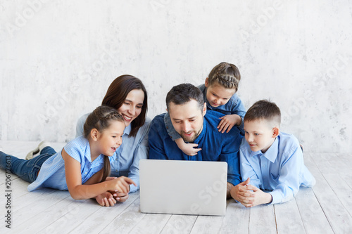 Large family with gadgets. Parents and children at laptops