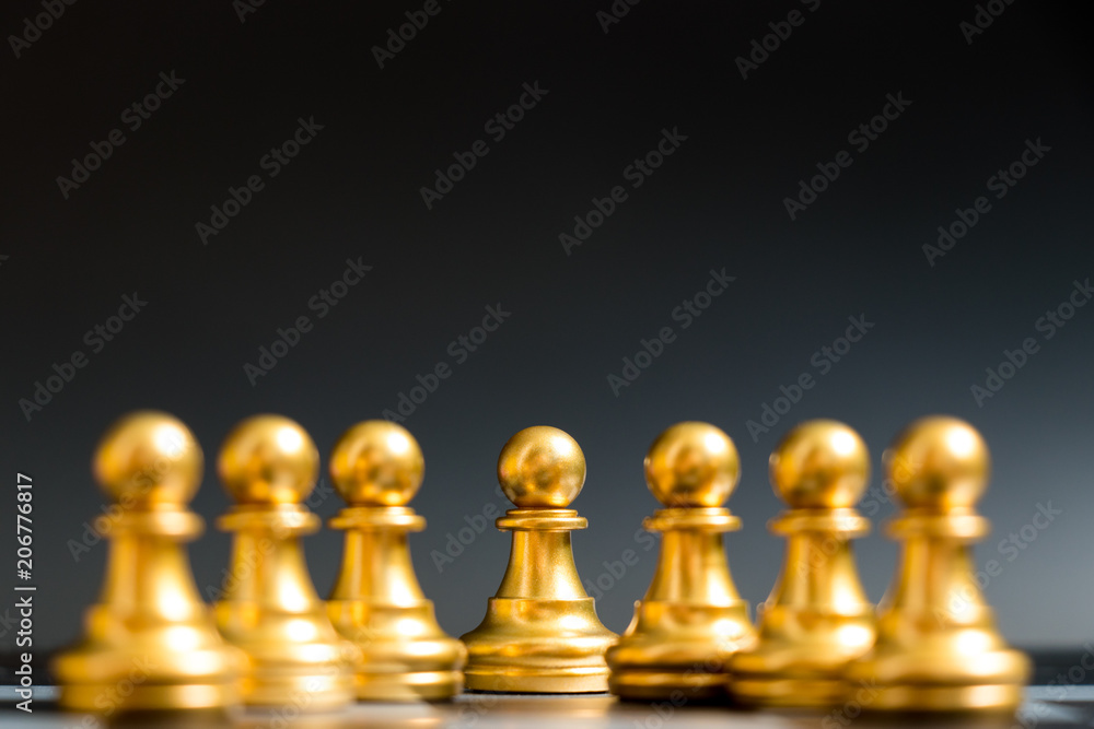 Gold Pawn chess piece stand with other on black background Gold Pawn chess piece stand with other on black background