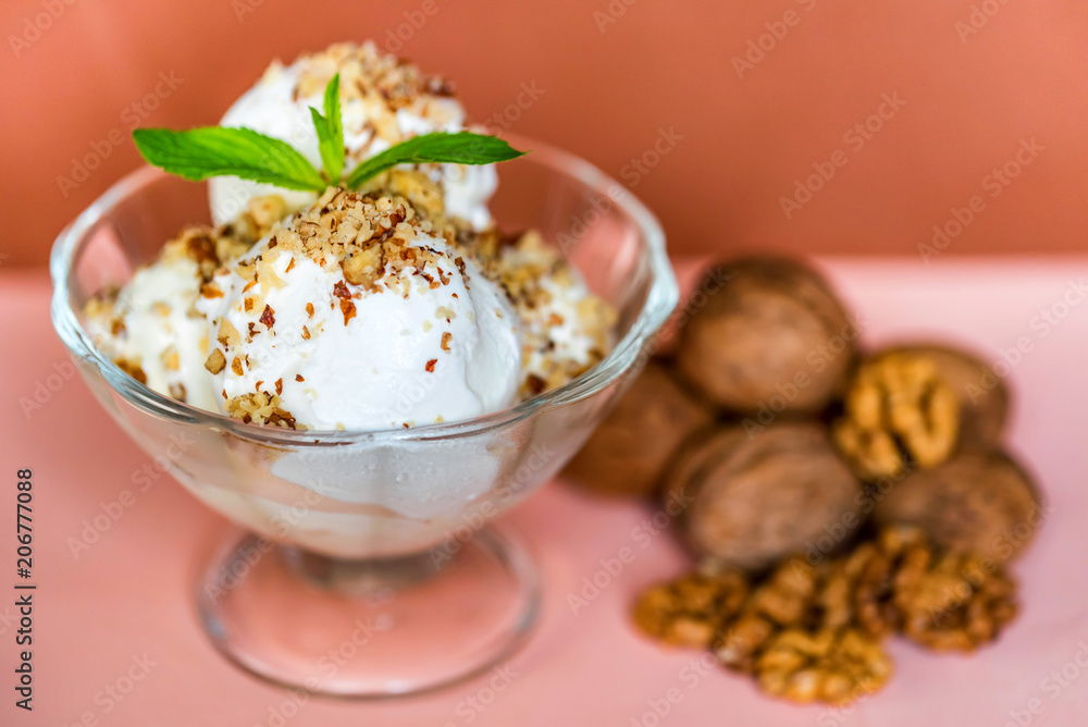 Vanilla ice cream in bowl and walnuts