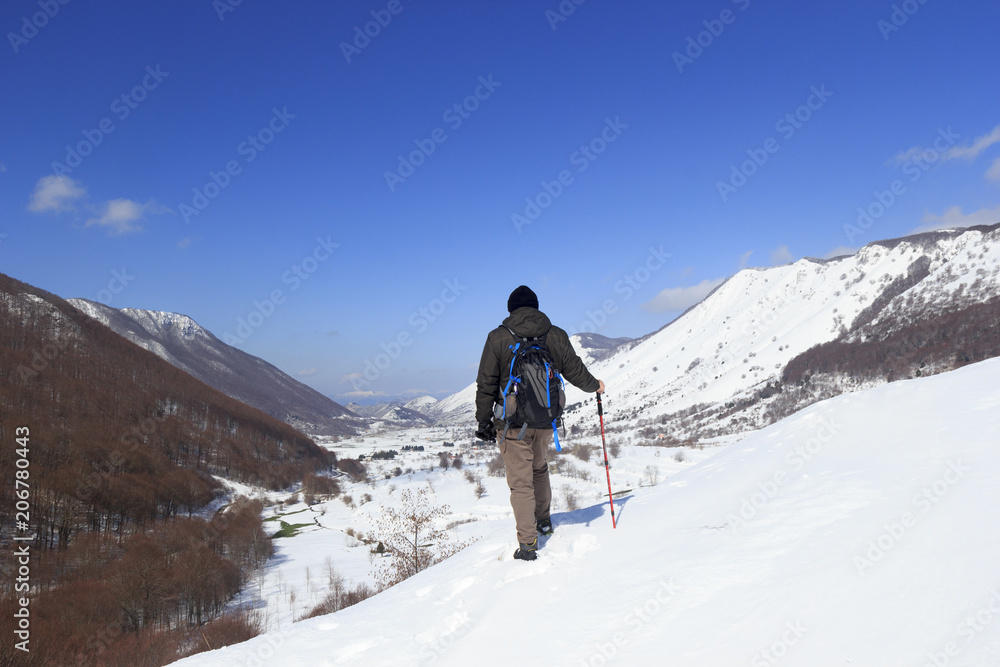 hiker and valley in snow