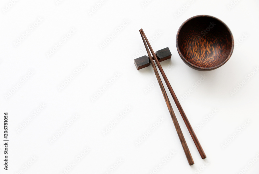 old wood chopsticks and wood bowl on White table background.Flat lay,Copy space
