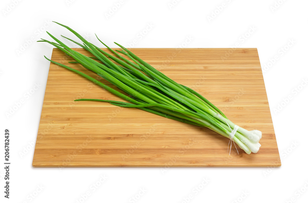 Bunch of green onion on the bamboo cutting board Bunch of green onion on the bamboo cutting board