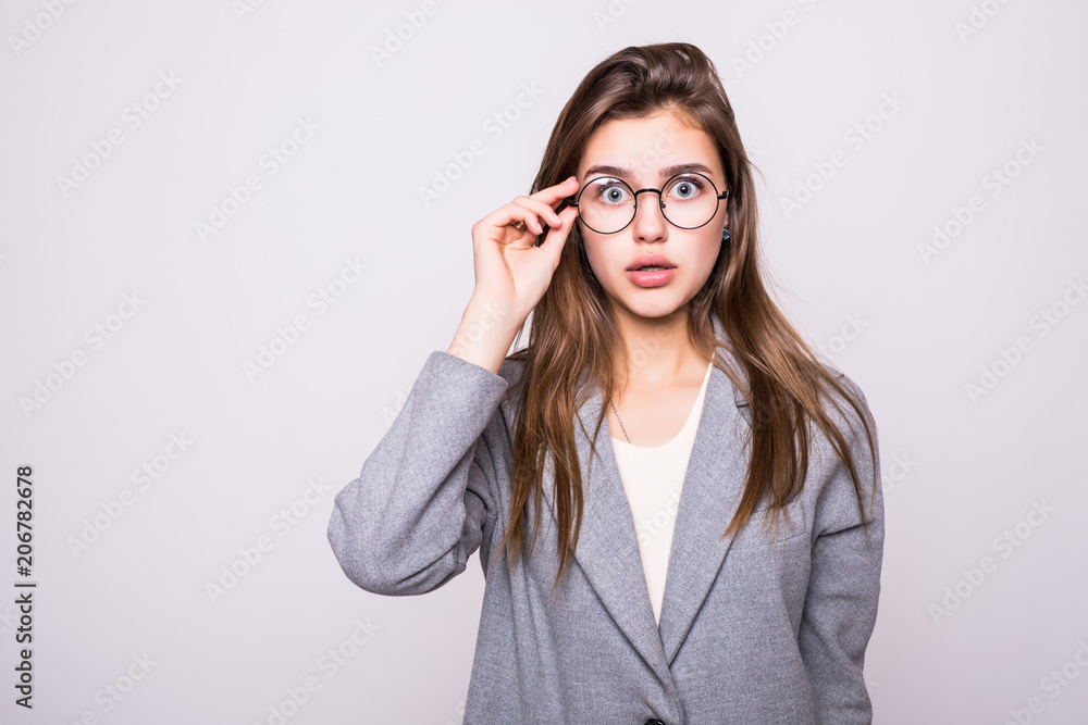Pretty smiling woman in eyeglasses looking at the camera over white Pretty smiling woman in eyeglasses looking at the camera over white
