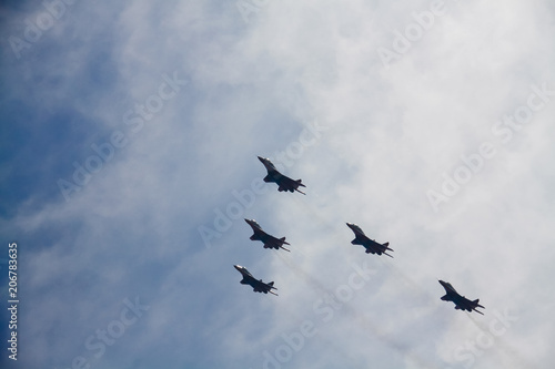 Five military aircraft flying in the sky