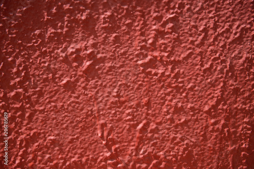 inaccurately painted red surface with stains of paint