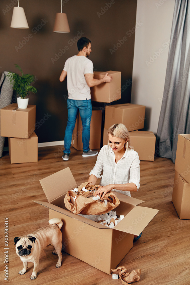 Fototapeta premium New House. Man And Woman With Boxes