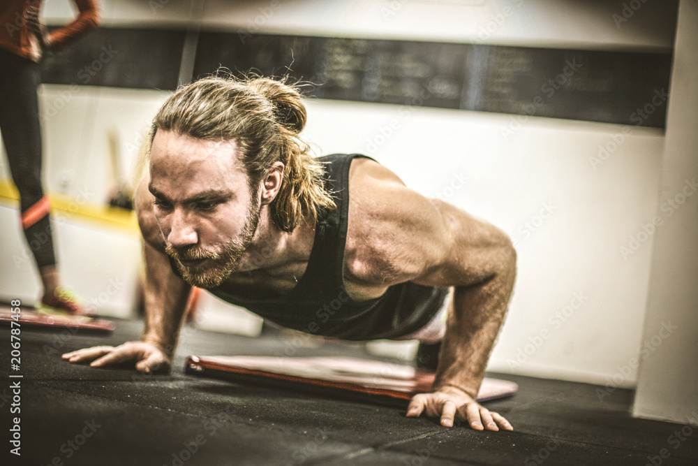 Fototapeta premium Young men exercise. Portrait.