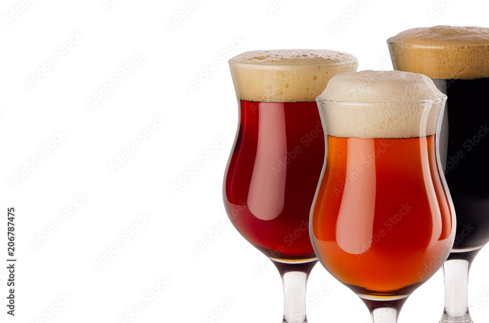 Different beer in goblet with foam closeup - lager, red ale, porter - isolated on white background. Different beer in goblet with foam closeup - lager, red ale, porter - isolated on white background.