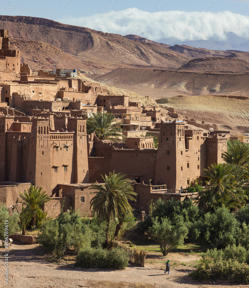 view to towers of fortress and mountains with clouds in Morocco
