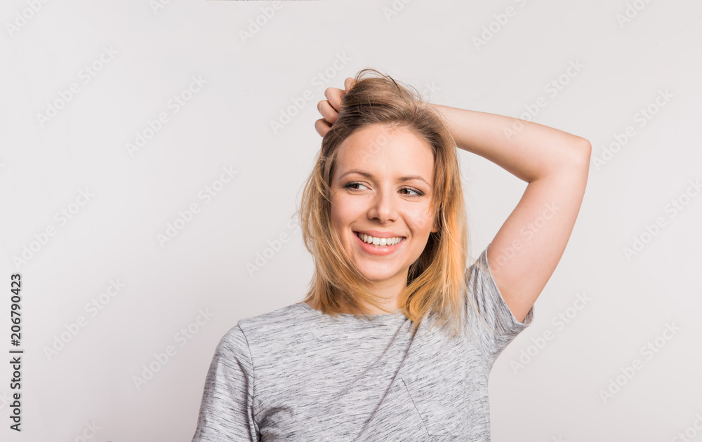 Portrait of a young beautiful woman in studio on a white background. Portrait of a young beautiful woman in studio on a white background.