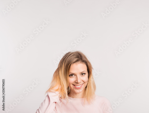 Portrait of a young beautiful woman in studio on a white background.