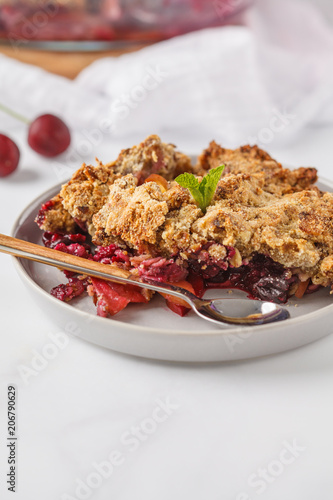 Summer berry crumble pie, light background, vegetarian breakfast. Healthy vegan food concept.