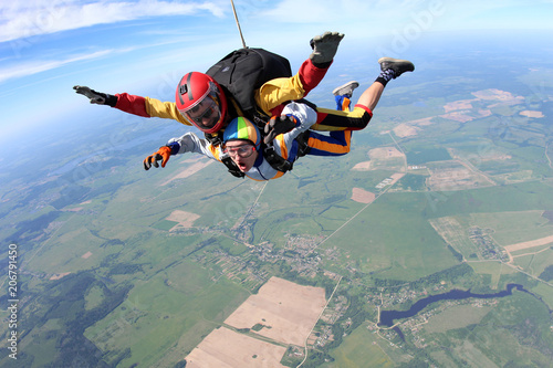Skydiving. Man and woman are doing tandem jump.