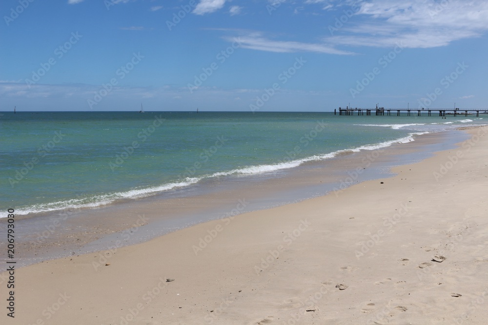 Endless white sand beach with pier In Glenelg, South Australia Endless white sand beach with pier In Glenelg, South Australia
