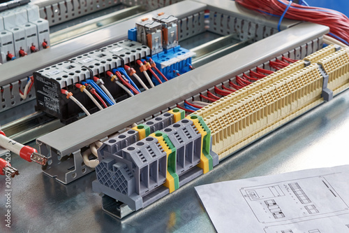 Terminals, contactors, relays, circuit breakers and electrical Cabinet drawing. Electrical wires or cables are connected to electrical equipment according to the project. Modern technologies, design.