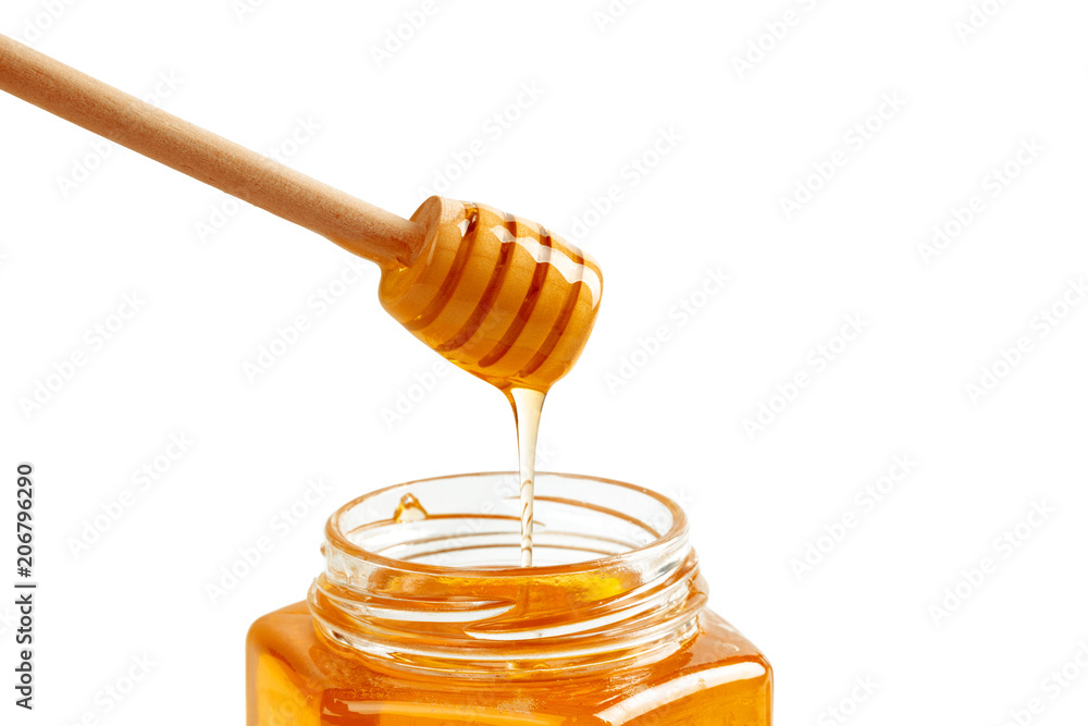 honey with wooden drizzler isolated on white background honey with wooden drizzler isolated on white background