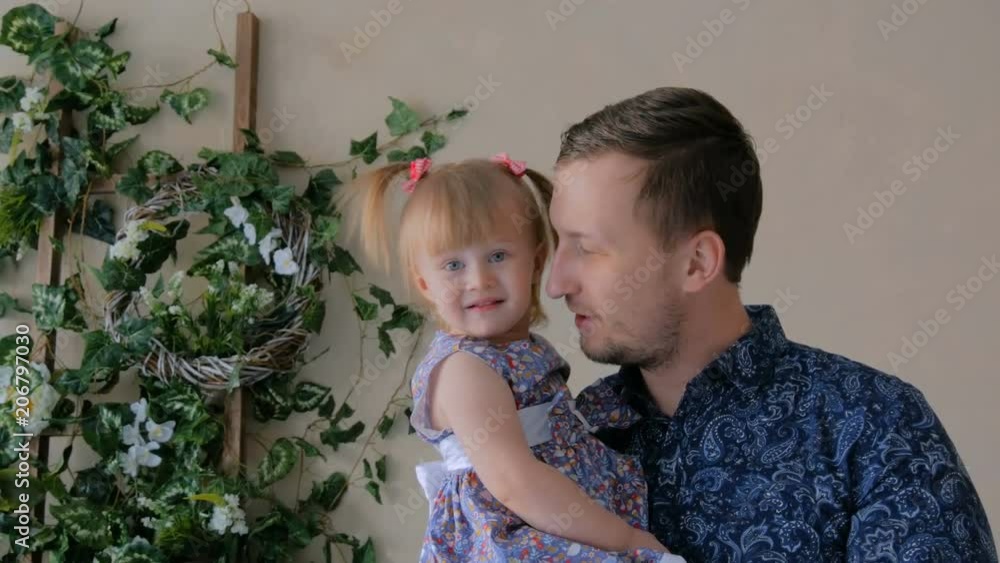 Portrait of funny little girl and her father at home. Family, childhood and leisure concept Portrait of funny little girl and her father at home. Family, childhood and leisure concept