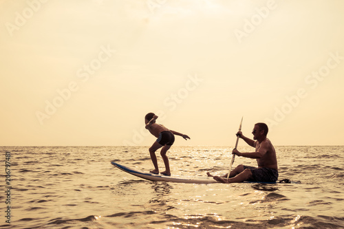 Father and son  playing on the beach at the day time.