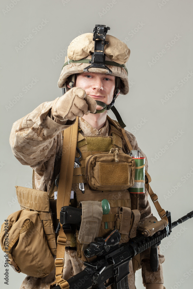 Soldier in camouflage holding rifle Soldier in camouflage holding rifle
