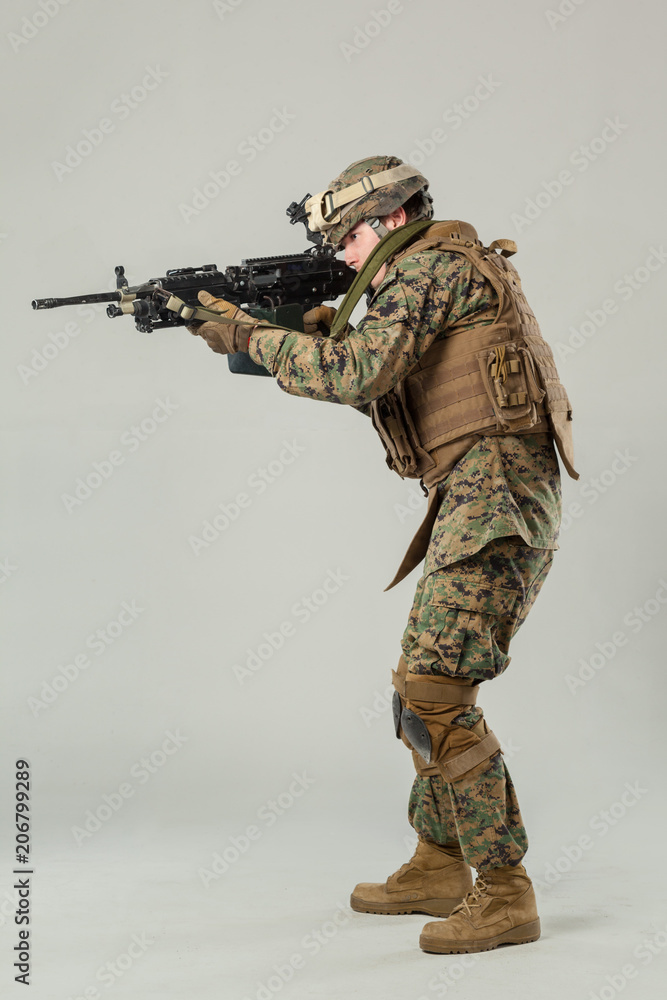 Soldier in camouflage holding rifle Soldier in camouflage holding rifle