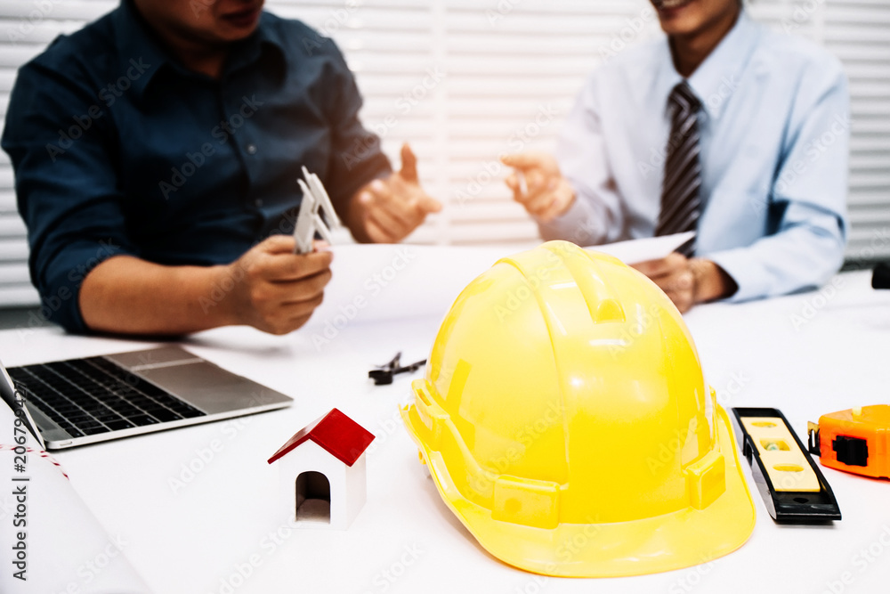 Engineers and businessmen are discussing construction projects in workplace. Construction concept. Engineers and businessmen are discussing construction projects in workplace. Construction concept.