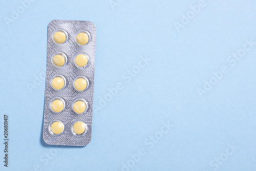 Yellow round pills in  package  photo