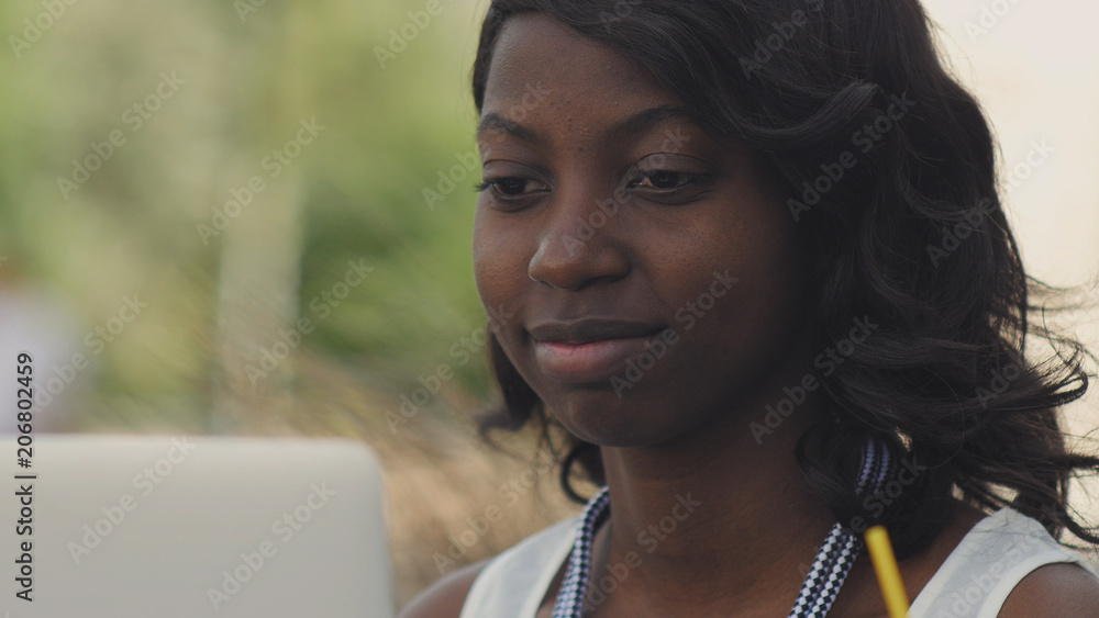Beautiful woman having video chat on laptop computer outsite in the city Beautiful woman having video chat on laptop computer outsite in the city