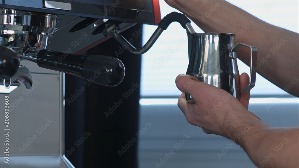 Professional barista shaking milk in coffee shop Professional barista shaking milk in coffee shop