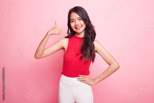 Young Asian woman show thumbs up.